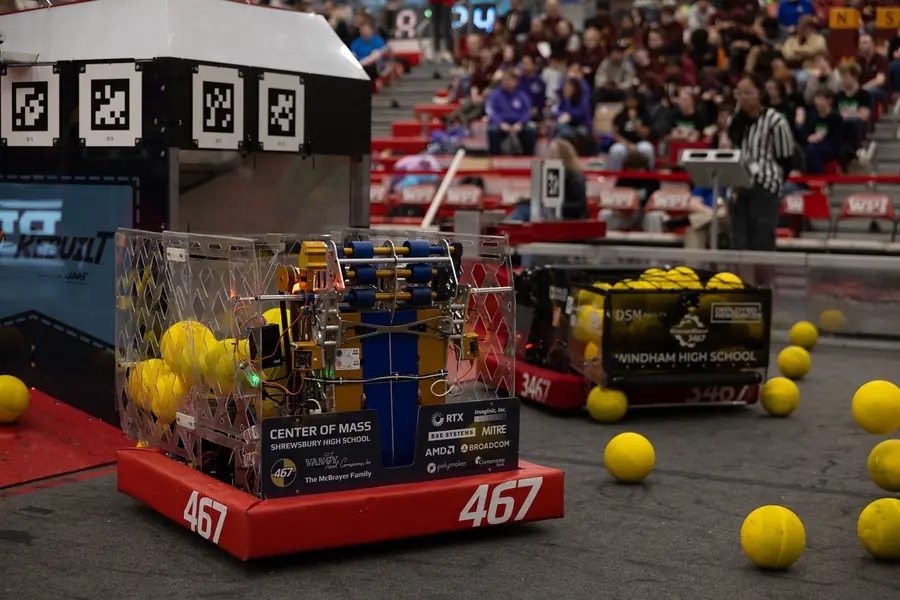 The V1 robot on the competition field surrounded by yellow game pieces